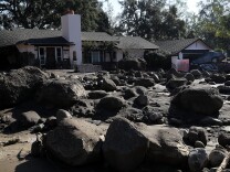 Boulders and mud stand in front of a home that was destroyed by a mudslide on January 11, 2018 in Montecito, California.