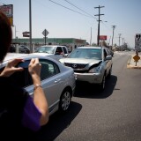 SAN GABRIEL, CA - JUNE 11: Hin Lee takes a photo of his car after getting into a accident at the 400 block of South San Gabriel Boulevard June 11, 2012 in San Gabriel, California. This intersection was the scene of the first of two accidents that occurred June 9, involving Commerce Secretary Bryson. The Commerce Department has said that Bryson had suffered seizures.  (Photo by Jonathan Gibby/Getty Images)