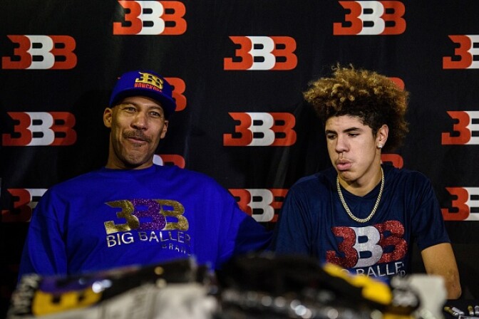 LaVar Ball (L), father of basketball player LiAngelo Ball and the owner of the Big Baller brand, sits with his other son LaMelo Ball during a promotional event in Hong Kong on November 14, 2017.
UCLA players LiAngelo Ball -- the younger brother of Los Angeles Lakers rookie star Lonzo Ball -- and teammates Cody Riley and Jalen Hill were arrested on November 7 in Hangzhou ahead of their regular-season-opening game against Georgia Tech in nearby Shanghai this past weekend. ESPN reported that they were nabbed on suspicion of stealing from a Louis Vuitton store and later freed on bail but ordered to remain in Hangzhou.  / AFP PHOTO / Anthony WALLACE        (Photo credit should read ANTHONY WALLACE/AFP/Getty Images)