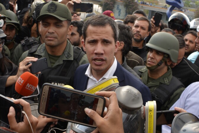 CARACAS, VENEZUELA - APRIL 30: Venezuelan opposition leader Juan Guaidó, recognized by many members of the international community as the country's rightful interim ruler, talks to media outside the airforce base La Carlota on April 30, 2019 in Caracas, Venezuela. Through a live broadcast via social media, Venezuelan opposition leader Juan Guaido called for a military uprising against the government of Nicolás Maduro. He declared to be at the air base of La Carlota and was seen surrounded by soldiers and opposition activist Leopoldo Lopez, who was under house arrest. (Photo by Rafael Briceno/Getty Images)
