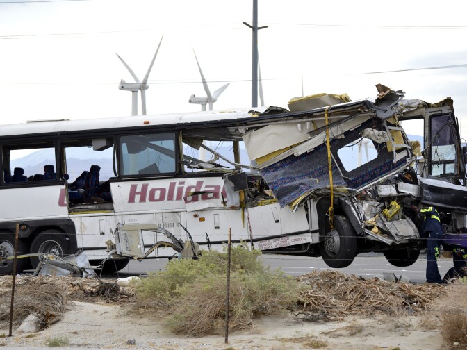 File: Workers prepare to haul away a tour bus that crashed with semi-truck on Interstate 10 just west of the Indian Canyon Drive off-ramp, in Desert Hot Springs, near Palm Springs, Calif., Sunday, Oct. 23, 2016.