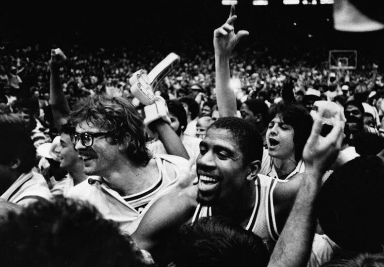 After Lakers won the world title in 1982, fans stormed onto Forum floor and celebrated with the players, including Kurt Rambis and Magic Johnson.