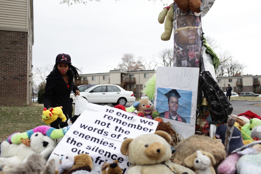 FERGUSON, MO - NOVEMBER 22: Marneisha Jones places a stuff animal at a makeshift memorial for Michael Brown November 22, 2014 in Ferguson, Missouri. Brown, a 18-year-old black male teenager was fatally wounded by Darren Wilson, a white Ferguson Police officer on August 9, 2014. A 12-member grand jury is reviewing evidence to decide whether or not to indict Wilson on charges.  (Photo by Joshua Lott/Getty Images)