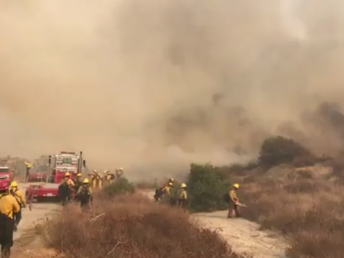 Hand crews clear line around the Canyon Fire on Monday, Sept. 25, 2017.