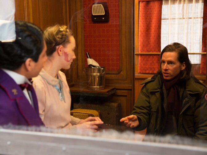 Director Wes Anderson directs Saoirse Ronan and XX in "The Grand Budapest Hotel."