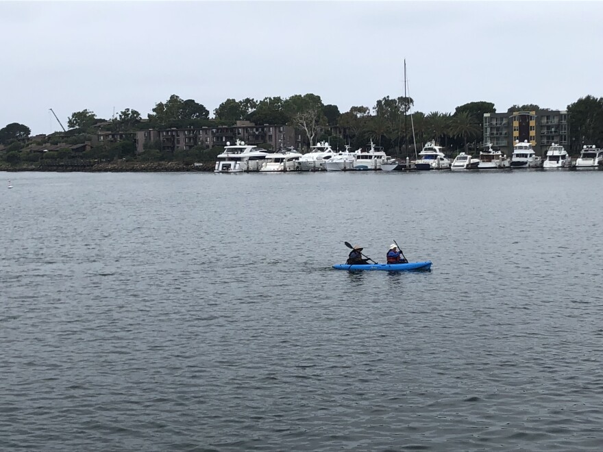 Two kayakers paddle through Marina Del Rey's main channel.