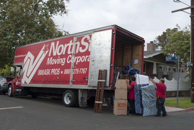 Movers from NorthStar Moving Corporation load a truck with possessions from a newly sold home in Central Los Angeles.