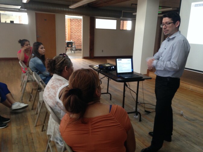 Participants in an asylum legal clinic at the Central American Resource Center listen to a  presentation by staff attorney Eryk Escobar. The free clinics are attended by recently-arrived immigrants, most from Central America, who wish to represent themselves in immigration court as they seek asylum in the United States. With pro-bono and low cost legal providers maxed out, many can't afford immigration lawyers.