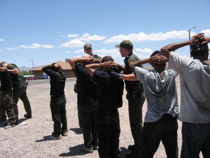 Border Patrol agents arrest migrants in 2007 after they illegally crossed into Nogales, Ariz. Operation Streamline puts such people into federal courts, giving them criminal records. The Border Patrol says the program allows the agency to focus on more serious crime, but federal judges say it causes backups in the system.