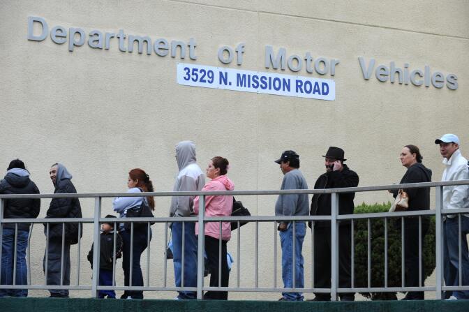 File: People wait in line outside of the State of California Department of Motor Vehicles (DMV) in Los Angeles, California on February 13, 2009.   