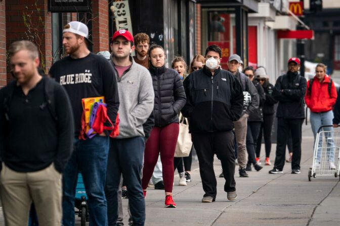 WASHINGTON, DC - APRIL 01: People wait in a line to get into a Trader Joe's grocery store on April 1, 2020 in Washington, DC. As of April 1, the entire national capital region is under 'stay-at-home' orders, which ban residents from leaving their homes except to perform essential activities and visit essential businesses. (Photo by Drew Angerer/Getty Images)
