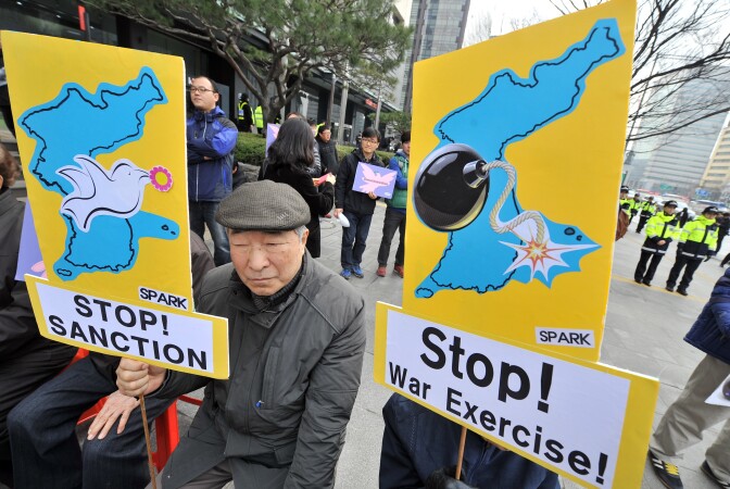 Anti-war activists hold placards showing the Korean Peninsula during a protest against a joint military exercise between South Korea and the US, called Key Resolve, near the US embassy in Seoul on March 12, 2013. North Korea leader Kim Jong-Un threatened to 'wipe out' a South Korean island as Pyongyang came under new economic and diplomatic fire on March 12, from US sanctions and UN charges of gross rights abuses.