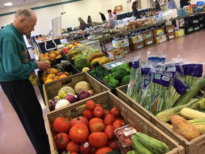 A volunteer with the Saddleback Church prepares produce as part of the group's food pantry on the Camp Pendleton Marine Base near San Diego, April 5, 2017. The church typically serves about 100 active duty military families as part of its monthly food pantry.