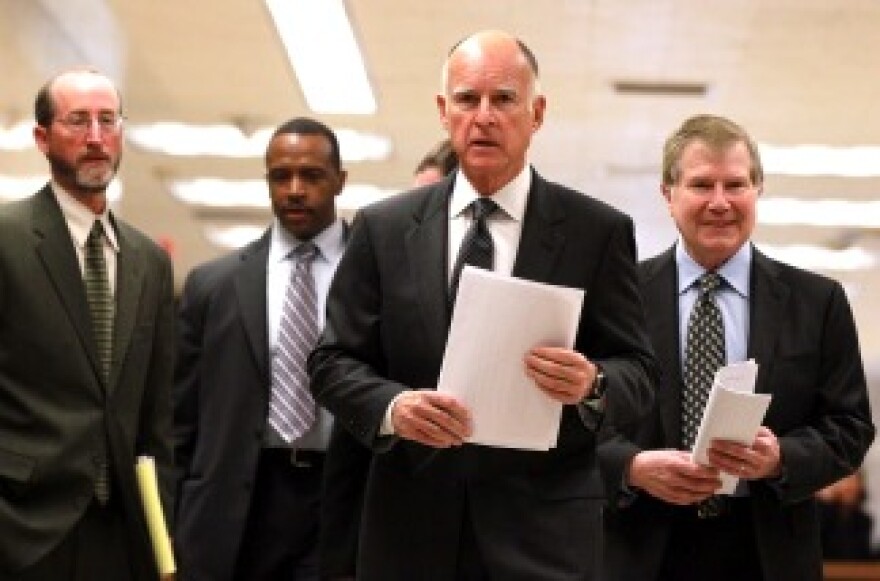 Gov. Jerry Brown walks with advisors to a press conference about his proposed budget at the California State Capitol on Jan. 10, 2011 in Sacramento.