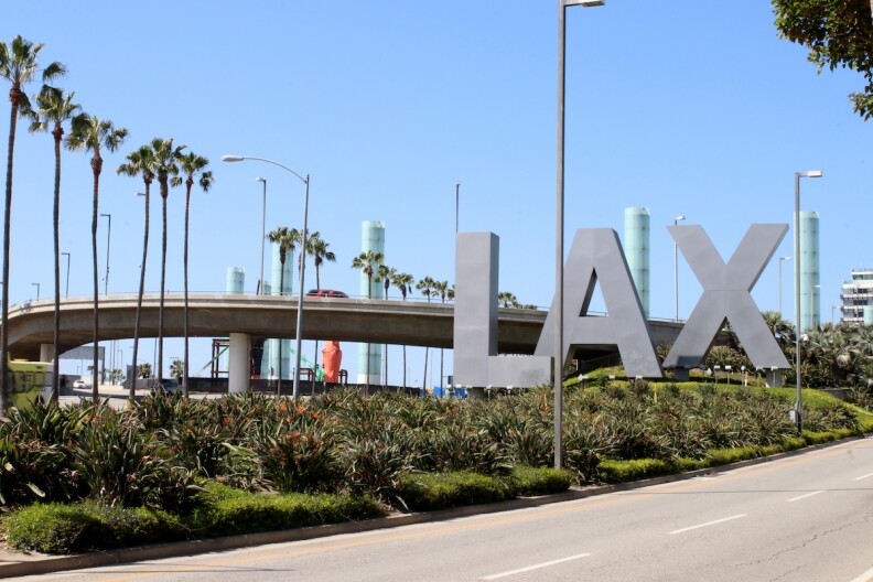 Giant L A X letters mark the entrance to Los Angeles International Airport.