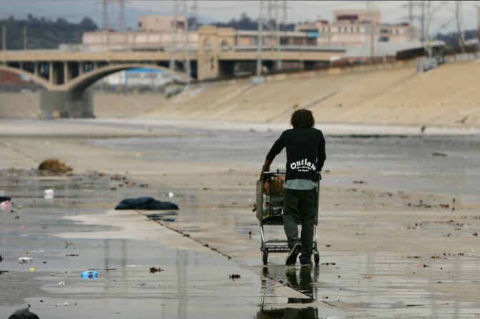 JANUARY 18: A man who goes by the name 'Pepper' pushes his cart along concrete banks of the Los Angeles River on January 18, 2006 in Los Angles, California. Pepper says he began a life of roaming after his father, a member of the Klu Klux Klan (KKK), kicked him out of the house for bringing home a Native American bride from the Blackfoot tribe. A recent comprehensive census and survey of homelessness in Los Angeles County by the federal Department of Housing and Urban Development found 88,345 homeless people in the city and surrounding communities, far exceeding any other county in the nation, or the five boroughs of New York which by contrast have only 48,155 homeless people. (Photo by David McNew/Getty Images)