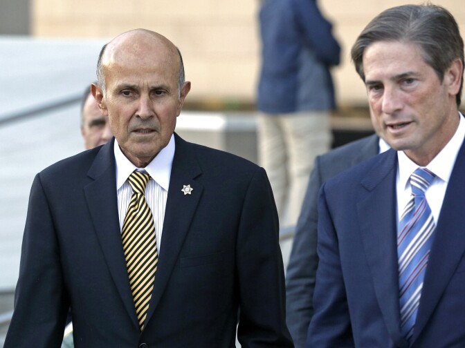 Former Los Angeles County Sheriff Lee Baca, left, and his attorney Nathan Hochman leave federal court in Los Angeles, Monday, Dec. 19, 2016, after the prosecution and defense presented their closing arguments and the case went to the jury. The longtime lawman is charged with conspiracy and obstruction of justice for acts his subordinates carried out in August and September 2011, when his deputies discovered an inmate with a smuggled cellphone was an FBI informant using the device to document abuses.