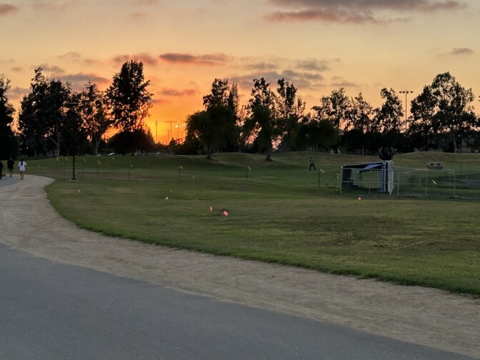 A tarped area behind a chainlink fence