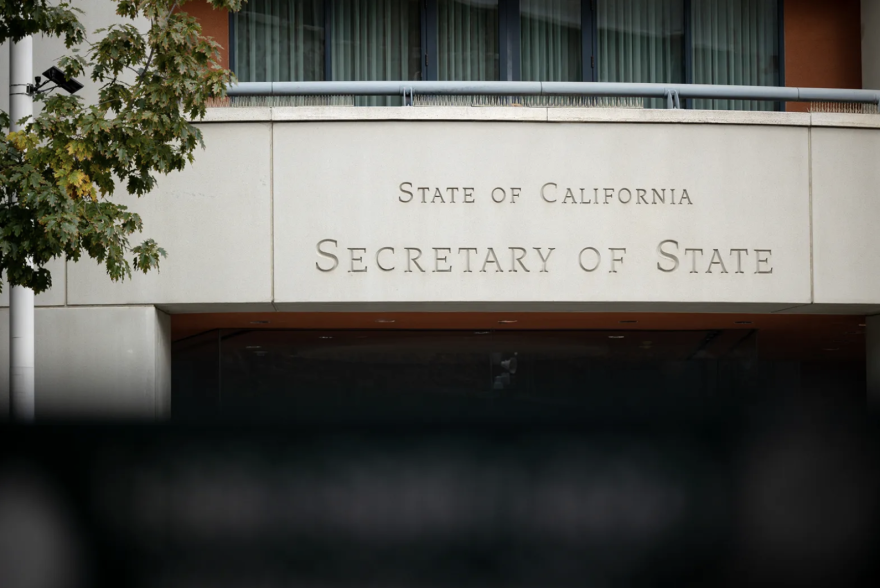 At a building entrance, etched in stone above are the words "State of California / Secretary of State."