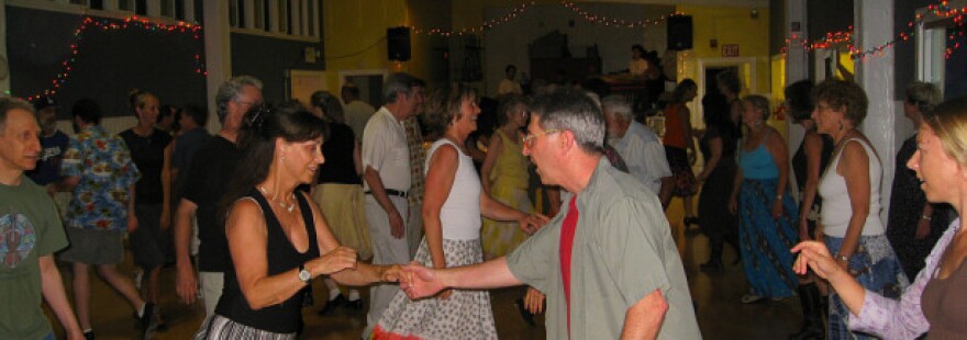 "Contradancing" is a form community dancing: in a given song, pretty much everyone dances with everyone else.  It also has a distinctive sound, as the caller shouts out the steps, the live band plays, and the dancers step and swing and stomp up and down the floor.      