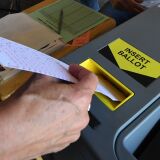 A woman inserts her ballot into the machine after voting at a Lifeguard headquarters that doubles as a polling station during the midterm elections  in Hermosa Beach, California, on November 6, 2018. - Americans started voting Tuesday in critical midterm elections that mark the first major voter test of US President Donald Trump's controversial presidency, with control of Congress at stake. (Photo by Mark RALSTON / AFP)        (Photo credit should read MARK RALSTON/AFP/Getty Images)