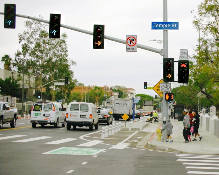 Flashing yellow right turn signals for drivers are seen along with a red bike signal at the intersection of Los Angeles and Temple streets in downtown L.A.