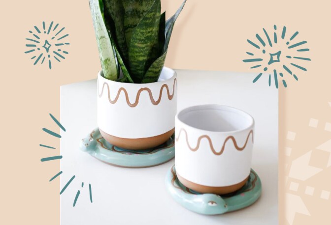 White ceramic and terracotta pots rest on a coaster shaped like a snake.