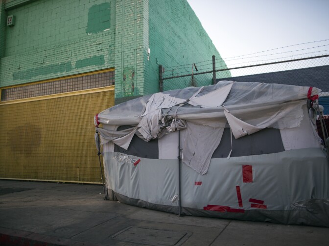 A tent stands on E Sixth Street at Gladys Avenue in Skid Row on Thursday morning, Dec. 17, 2015. 