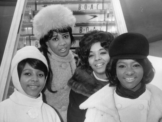 7th February 1964: Phil Spector's American soul singing group The Crystals, from left to right; Barbara, Dee Dee, Fran and La La, all wrapped up at London Airport for their first visit to this country, hot on the heels of their successful singles 'Then He Kissed Me' and 'Da Doo Ron Ron'.