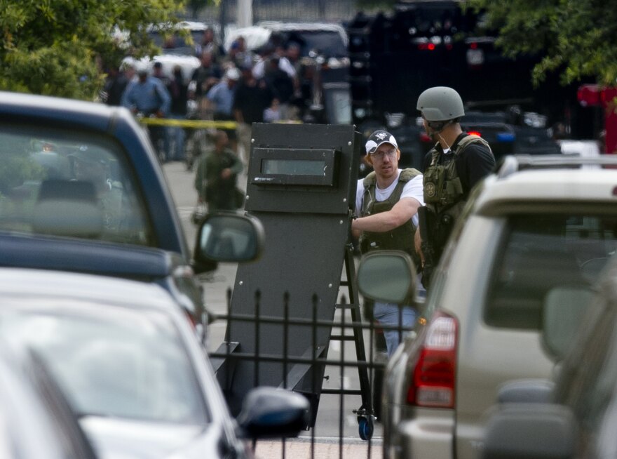 Police tactical units leave after responding to a shooting at the Navy Yard in Washington, DC, September 16, 2013. A shooting rampage at the Washington naval base claimed at least 12 lives including that of an unidentified gunman, city police chief Cathy Lanier told reporters Monday. 