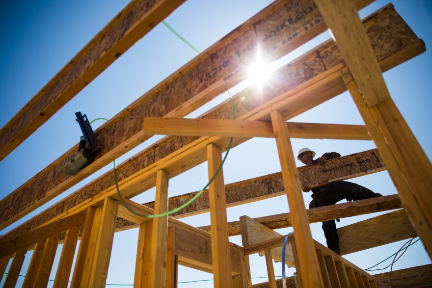 Walter Cruz works on a new home in Mountain House, California. As a master-planned community, Mountain House has a mountain of debt that they can only service by building more homes – despite their uncertainty of their water supply.