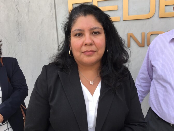 Victoria Carias outside the federal building on Los Angeles Street on Monday, after her husband, an evalgelical pastor, was detained there during a meeting with immigration officials.