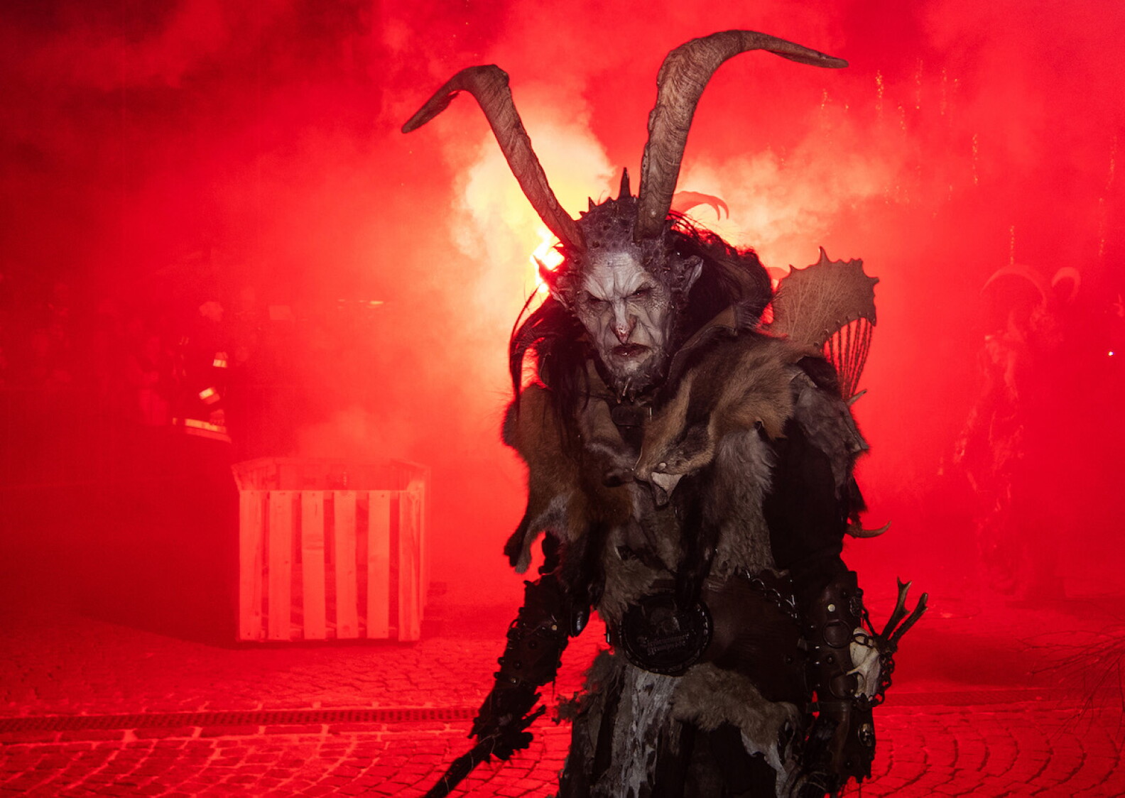 A creature with tall horns and a pale, scrunched face scowls forward.