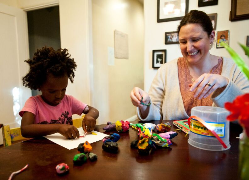 Trista and Luli Schroeder play with modeling clay in their home after school on Monday, Dec. 3.