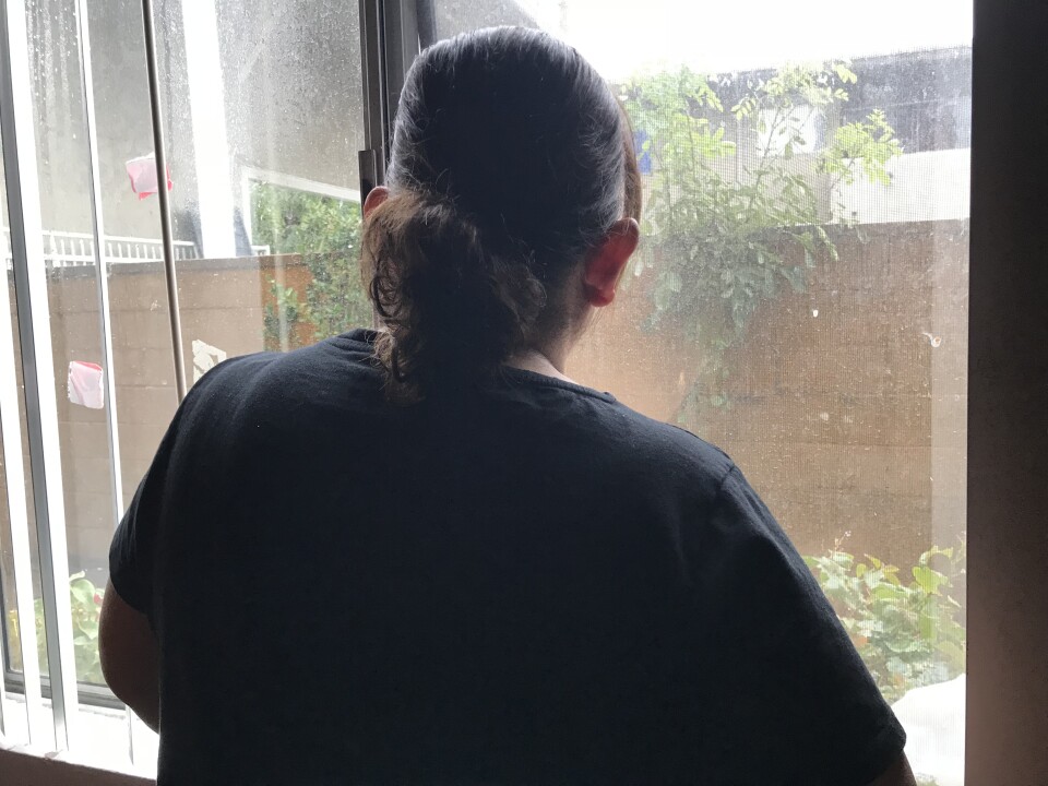 Lizeth looks out the window of her apartment in Los Angeles, Dec. 6, 2018.
