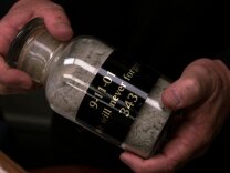 Redlands Fire Chief Jeff Frazier holds a sealed jar of dust from New York City's Ground Zero.