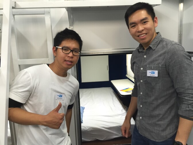 Kevin and Ken Pham hangin' out near their comfy invention: the Nappify pod. 