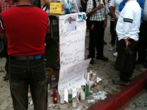 People gather at the memorial for Manuel Jamines, a Guatemalan immigrant who was shot and killed by an LAPD officer at Sixth Street and Union. The shooting has prompted angry protests.