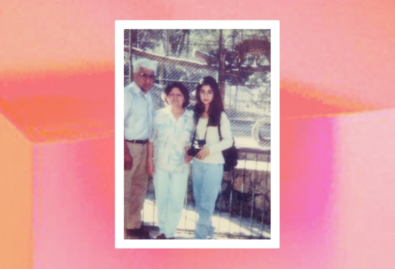 A young woman stands to the left of an older couple. She has a camera around her neck