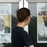 WASHINGTON, DC - MAY 02:  A passer by looks at newspaper headlines reporting the death of Osama Bin Laden, in front of the Newseum, on May 2, 2011 in Washington, DC. Last night U.S. President Barack Obama announced that the United States had killed the most-wanted terrorist Osama Bin Laden in an operation led by U.S. Special Forces in a compound in Abbottabad, Pakistan.   (Photo by Mark Wilson/Getty Images)