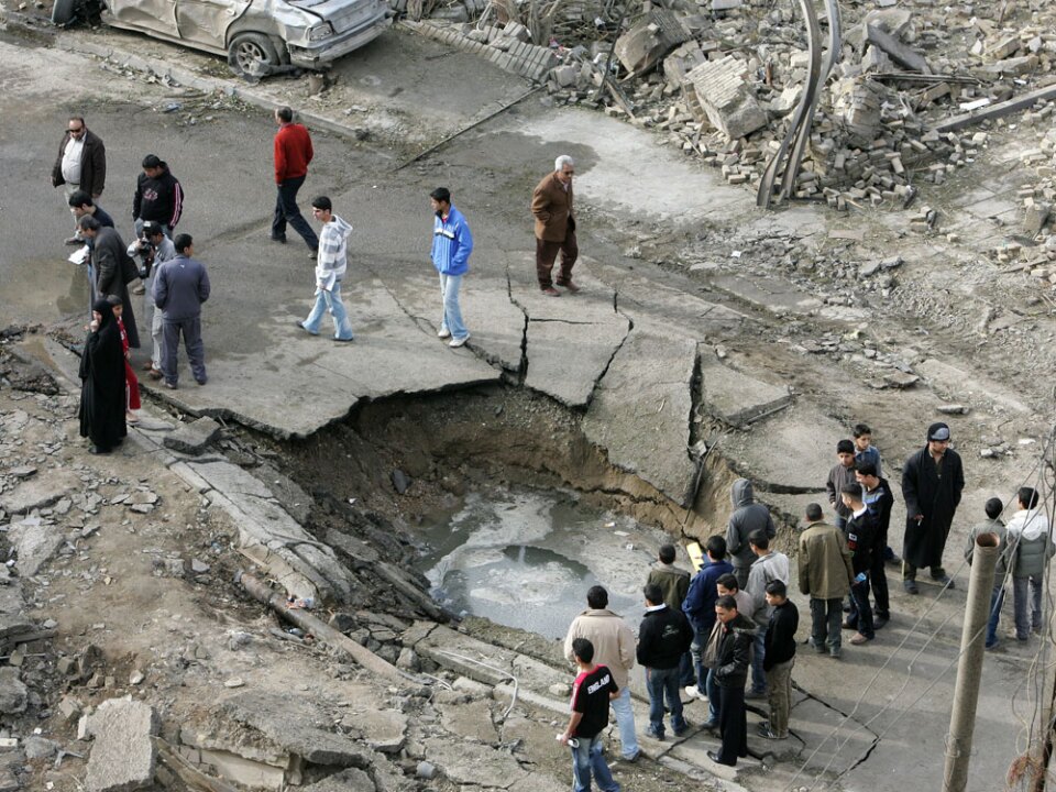 A crater marks the site of a car bomb explosion Monday near the Al-Hamra hotel in Baghdad. Three car bombs exploded, targeting hotels used by foreign journalists and businessmen.