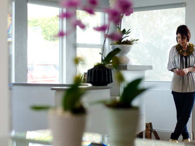 Cynthia Pastor, designer, stands inside the well-lit entrance to Salon Meritage in Seal Beach, Calif., Thursday, November 15, 2012. Open windows and light color tones help create a soft ambient lighting that is easy on the eyes.