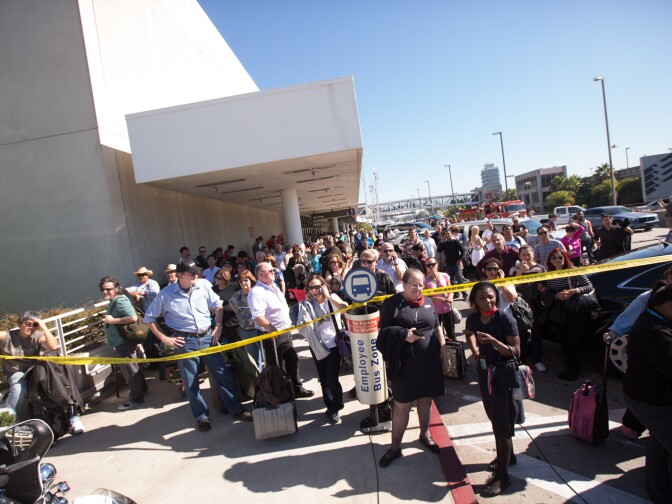Passengers wait at Terminal 1 after the LAX shooting on Nov. 1, 2013.