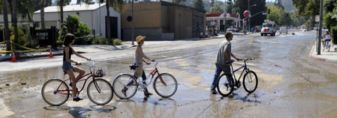 Residents cross what would normally be a busy Coldwater Canyon Avenue to inspect the damage after a 64-inch main broke Sept. 5, 2009, sending a deluge of water down Coldwater Canyon Avenue to Ventura Boulevard in the Studio City section of Los Angeles, flooding streets and businesses, Sunday, Sept. 6.