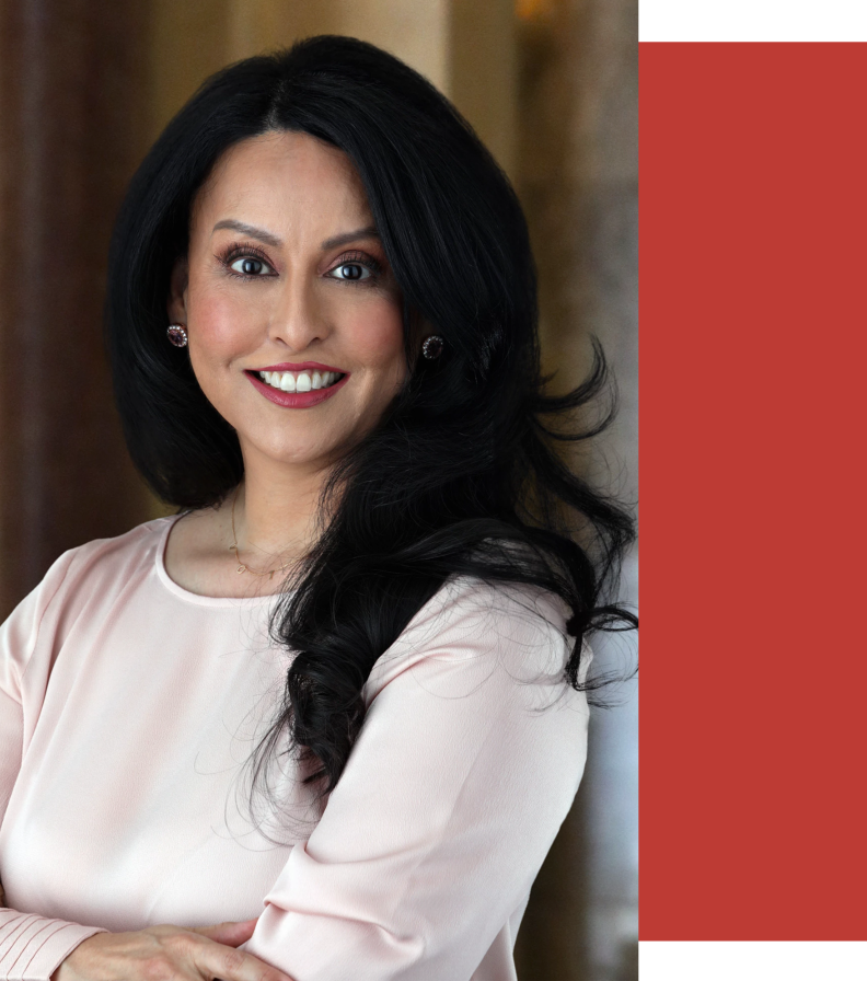Los Angeles City Council President Nury Martinez is photographed in a headshot smiling while wearing a blush colored dress with her arms folded.