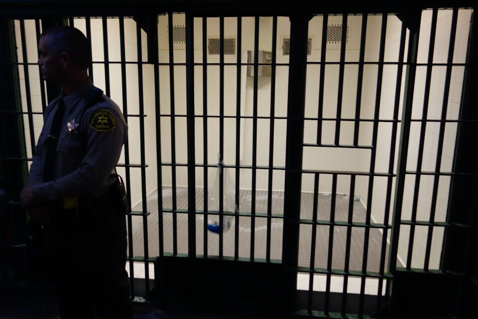                                A Los Angeles County Sheriff's Deputy stands in front of an empty cell at Men's Central Jail.