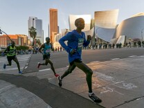 Los Angeles Marathon Elite runners, from left, Weldon Kirui, Simon Njoroge, Elisha Barno race past the Walt Disney Concert Hall in Los Angeles Sunday, March 18, 2018. Kirui won the Los Angeles Marathon with an unofficial time of 2 hours 11 minutes and 47 seconds. 