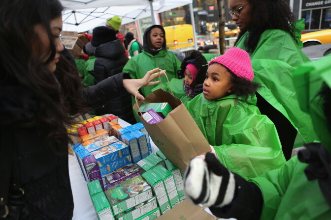 NEW YORK, NY - FEBRUARY 08:  Girl Scouts sell cookies as a winter storm moves in on February 8, 2013 in New York City. The scouts did brisk business, setting up shop in locations around Midtown Manhattan on National Girl Scout Cookie Day. (Photo by John Moore/Getty Images)