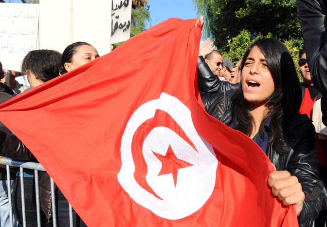File: A Tunisian woman holds a flag of Tunisia during a demonstration in front of the assembly on December 3, 2011 in Tunis.