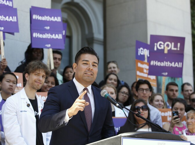 FILE - In this May 16, 2016, file photo, California state Sen. Ricardo Lara, D-Bell Gardens, speaks at a rally at the Capitol in Sacramento, Calif. California lawmakers are considering an audacious proposal that would substantially remake the state's health care system by eliminating insurance companies and guaranteeing coverage for everyone. Lara, who wrote the bill with Democratic Sen. Toni Atkins of San Diego, says they're working on details.